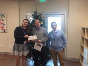 Attorney Barry P. Goldberg handing his $1000 donation to Los Angeles Family Housing.